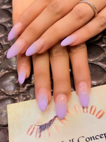 A soft and dreamy ombre on long, almond-shaped nails. This design features a beautiful gradient from a sheer nude base to a lovely lavender at the tips.