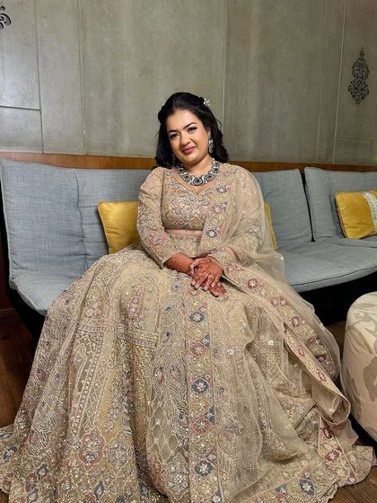 A full-length portrait of this bride in her gorgeous beige lehenga, looking regal and elegant.