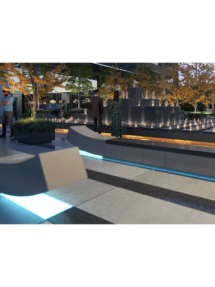 A dynamic, multi-tiered water feature serves as the plaza's centerpiece, adding the soothing sound of water and a strong visual anchor to the design.
