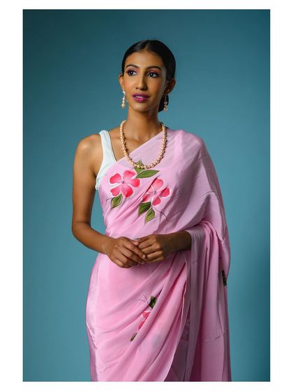 A close-up that provides a clear view of the model's face and the saree's color against her skin tone, which is a helpful reference for online shoppers.