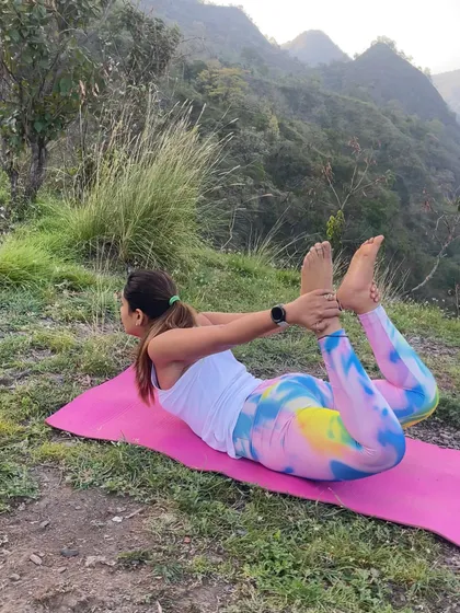 Dhanurasana, or Bow Pose, practiced outdoors. This asana is fantastic for strengthening the back muscles, improving posture, and stimulating the abdominal organs.
