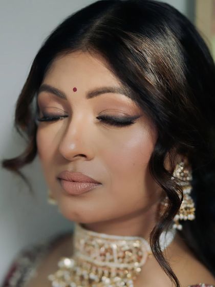 Eyes closed, this shot highlights the delicate eyeshadow work and the flawless finish of the skin. It’s a testament to the art of creating a natural yet polished bridal look.