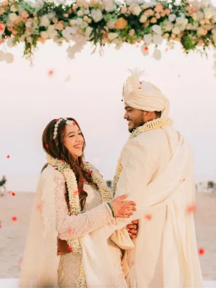 A beautiful shot of a bride at her Goa day wedding. The fresh, glowing makeup with soft glam details was perfect for the beachside ceremony and her ivory lehenga.