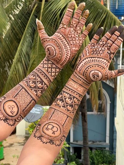 The full two-arm view of the engagement mehendi, showing the symmetry and balance in the design. The outdoor lighting really brings out the details.