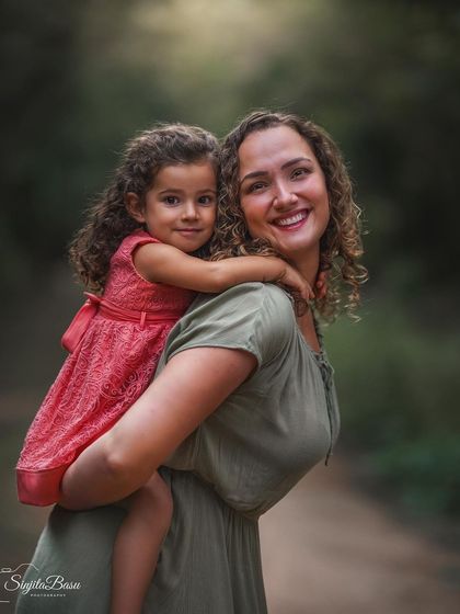 A piggyback ride is more than just play; it's a moment of trust, joy, and connection. This candid shot of Jordana and her daughter is full of life and happiness.