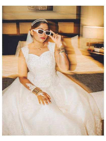 A fun and edgy bridal portrait using motion blur. The bride's cool sunglasses and pose show off her personality, adding a unique twist to the wedding gallery.