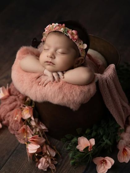A wider shot of the floral bucket setup, showing how the flowers and fabrics cascade beautifully to create a dreamy, enchanting scene.