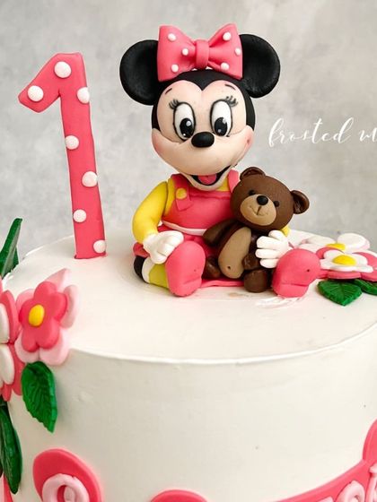 A sweet Minnie Mouse figurine, complete with her teddy bear, for a little one's first birthday. Classic characters are always a joy to create.