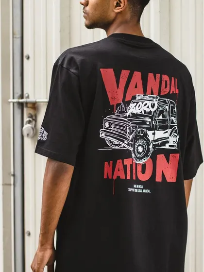 Another lifestyle shot of the 'Vandal Nation' T-shirt against an industrial background, highlighting its street-style aesthetic.