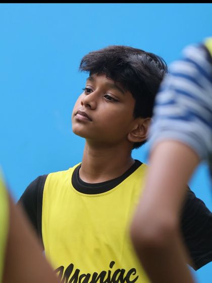 A young player listens intently during a break. We teach our players to be students of the game, always ready to learn.