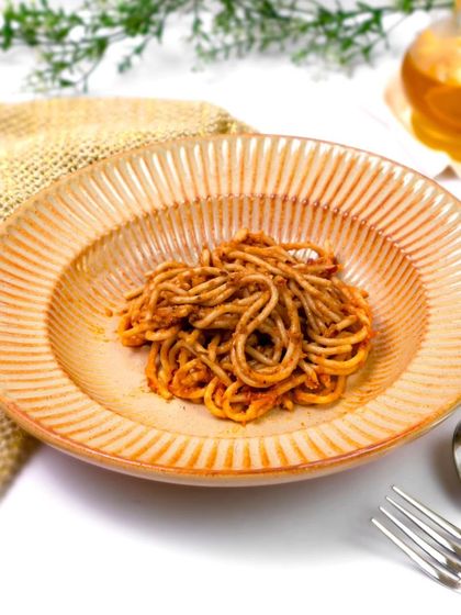 The pasta bowl is shown in use, filled with spaghetti. This practical, appetizing shot demonstrates the product's purpose and makes it easy for customers to imagine using it themselves.