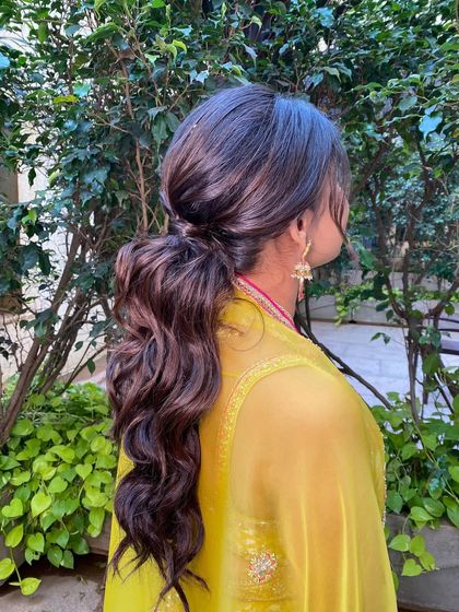 A simple, low ponytail with soft waves is an effortlessly elegant choice. This style is perfect for a daytime event or a more casual celebration.