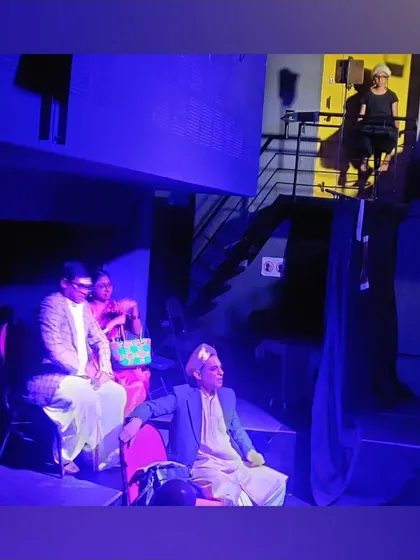 A multi level scene from a student production, with actors performing both on the main stage and on the balcony.