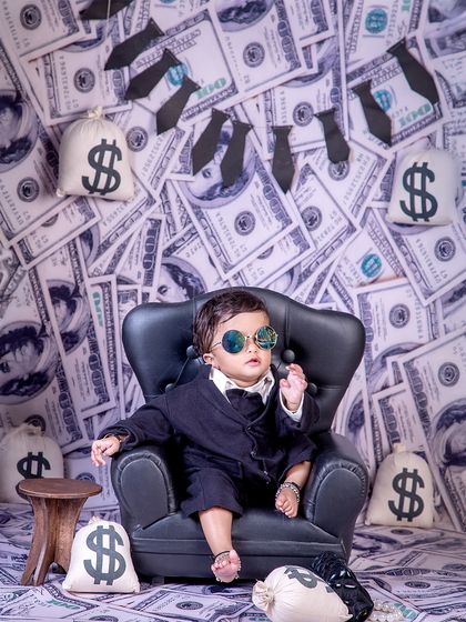 A power pose from the cash commander. This little one exudes confidence and style in the popular and fun money-themed photoshoot.
