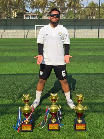 Coach Awais Shaikh, our Technical Director, stands proudly with the three championship trophies our teams brought back from Goa.