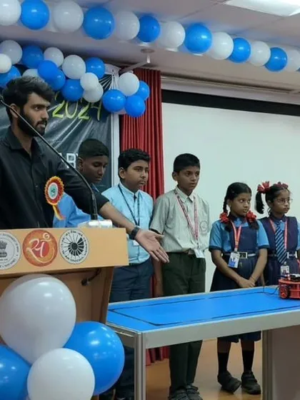 An instructor explains the workings of a robot to a group of young students at an Innovation Fair. These outreach activities are central to our mission of making tech education accessible.