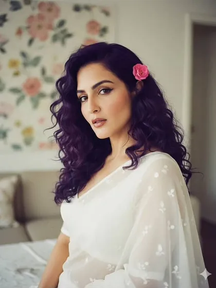 A slightly bolder version of the classic look, with a sharp winged liner and defined curls. The pink flower adds a touch of romance to this beautiful portrait.
