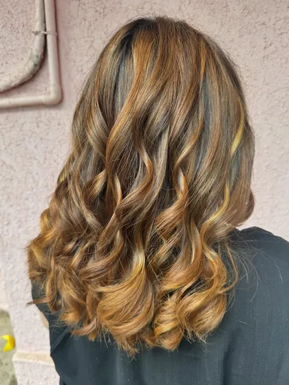 Another angle of the 'Golden Hour' look, showing the beautiful curls that enhance the color's dimension.