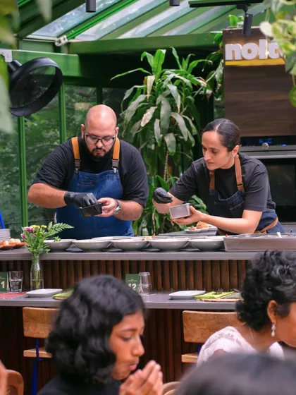 This is the focus and passion of my kitchen. Here, my co-chef Hanisha and I are plating dishes for a special event, ensuring every element is perfect before it reaches the table.