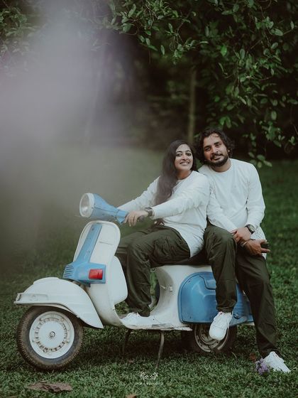 An artistic shot of the couple on a scooter, with a creative light leak effect adding a dreamy quality.