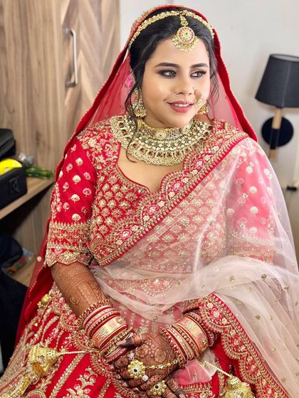 The bride looks elegant and poised, ready for her wedding ceremony. The traditional jewelry is perfectly balanced with the makeup.