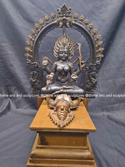 A striking sculpture of Kalika, the fierce goddess of time and destruction, standing over a prone Shiva. This Tantric form is crafted with a dark patina to emphasize her formidable nature.