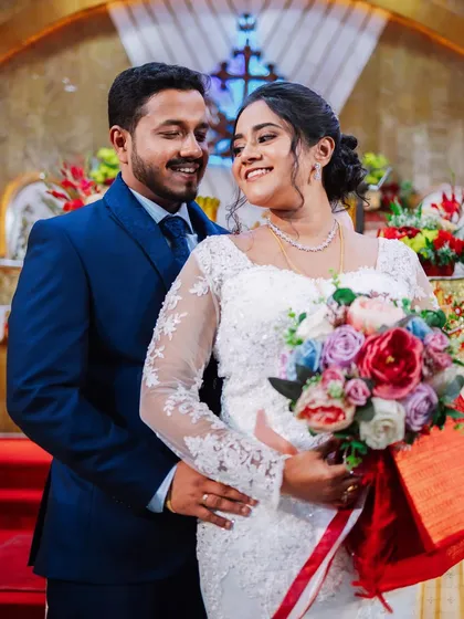 A sweet moment between the bride and groom. Her happy smile and his loving gaze make for a perfect wedding photo.