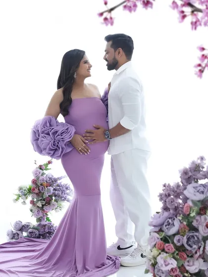A royal portrait in purple. This couple's shot is full of elegance and love, with the vibrant gown and floral setup creating a stunning visual.