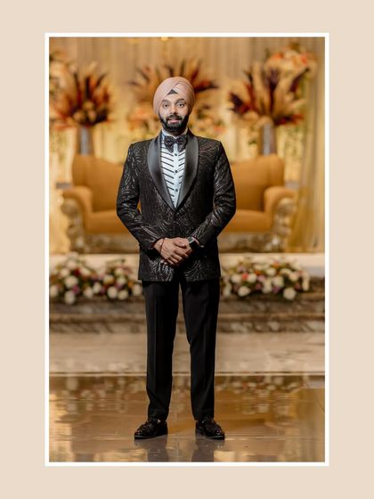 A classic, full-length portrait of the groom. His formal tuxedo and poised stance exude timeless elegance and sophistication.