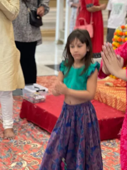 Teaching a dance step during the 'Namo Namo Shankara' song. Dancing is a joyful way to express devotion and celebrate together.