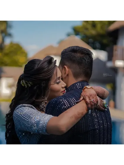 An intimate embrace by the pool. This close-up shot focuses on the couple's connection and the tender moment they are sharing.