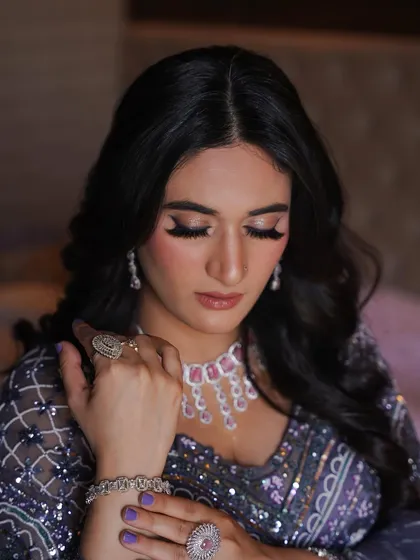 This shot highlights the beautiful winged eyeliner and the perfectly manicured nails that match the outfit.