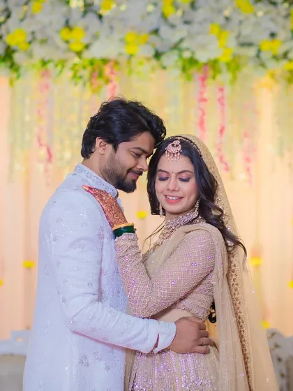 A romantic moment captured between the couple. The bride's makeup is soft and timeless, perfect for these cherished memories.