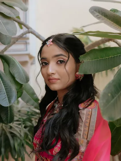 A close-up of the Haldi bride, where you can see the soft tendrils framing her face and the delicate waves in her hair.