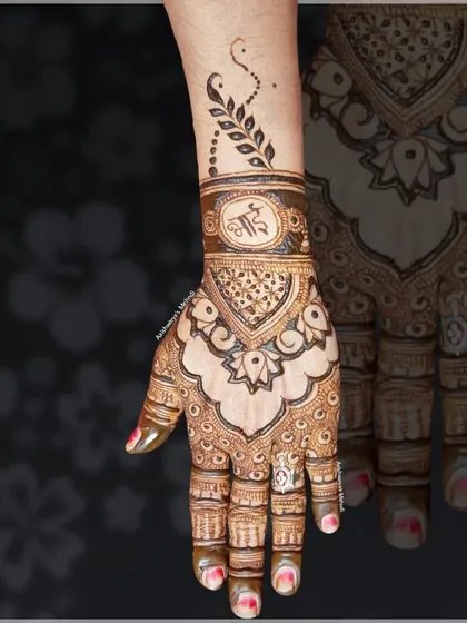 An elegant back-hand design personalized with the brother's initial for the festival of Raksha Bandhan.