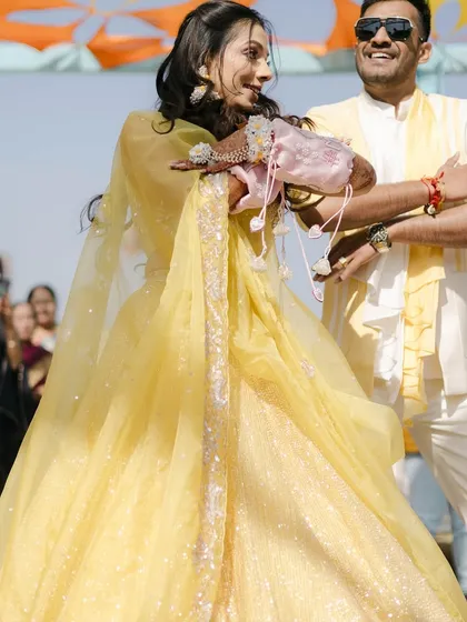 A beautiful shot of the couple during their Mehendi entry, full of joy and color.