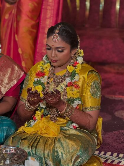 A moment of quiet reflection for the bride. The lighting highlights the beautiful shimmer on her eyelids and the rich colour of her saree and jewellery.