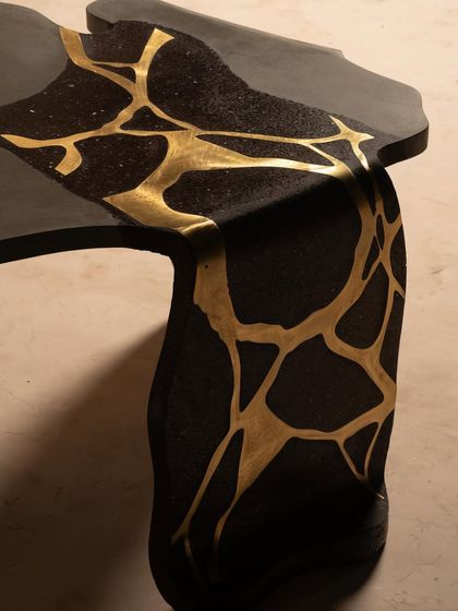A detail shot of the brass inlay flowing through the dark terrazzo of our Coral table. This is where nature meets design, creating a story of elegance and raw beauty in a single piece of furniture.