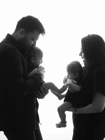 A beautiful silhouette of the family of four. This artistic black and white photo highlights their connection and the new shape of their family.