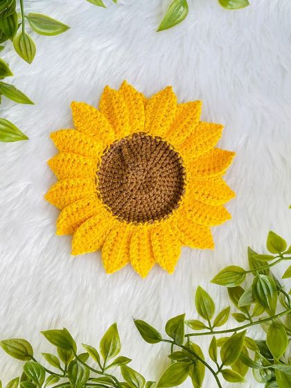 A close-up of the single-layer crochet sunflower, showing the neat stitching of the petals.