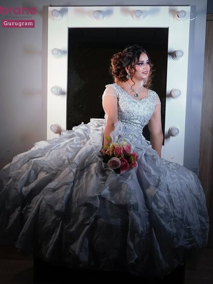 A beautiful shot of a student's work, featuring a model in a voluminous gown in front of a vanity mirror. This captures the dream and glamour of the beauty profession.
