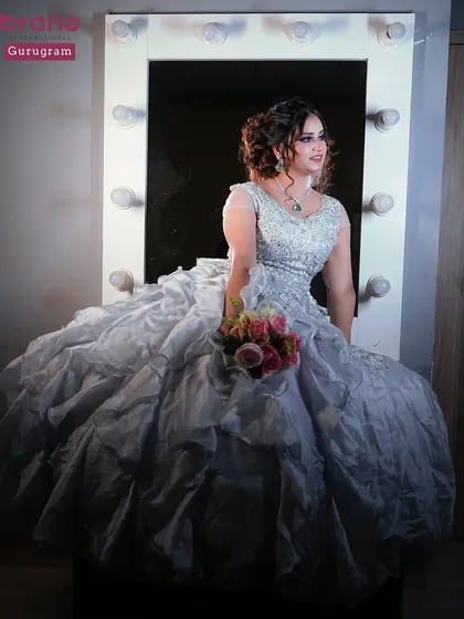 A beautiful shot of a student's work, featuring a model in a voluminous gown in front of a vanity mirror. This captures the dream and glamour of the beauty profession.