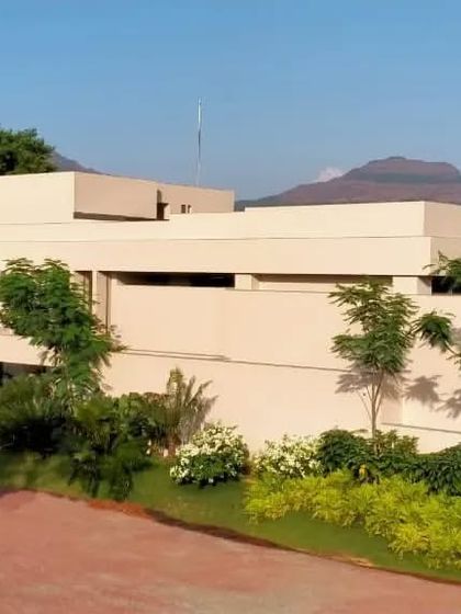 The "House in the Hills" project in Aamby Valley, viewed from its approach. The architecture is designed to sit comfortably within the hilly landscape, using natural materials and extensive greenery.