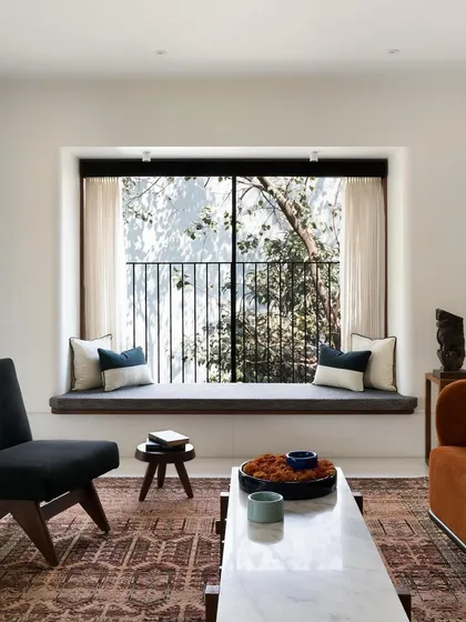 The living room's bay window seat, designed as a tranquil perch overlooking the trees. I focus on creating custom seating that not only looks beautiful but also enhances your connection to the views and light of your home.