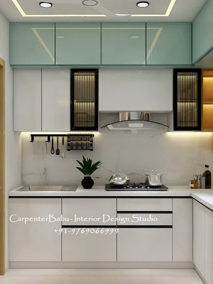 This modular kitchen design proves that you don't need a huge space to have a highly functional and stylish cooking area. I used a two-tone scheme with glossy white and mint green laminates, complemented by fluted glass cabinets and under-cabinet lighting. Every element is designed for efficiency, from the chimney to the accessible spice racks.