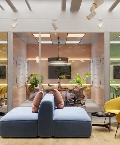 A view across the breakout lounge towards the glass-walled meeting rooms. Each room is infused with a different color, creating a visually dynamic and organized layout.