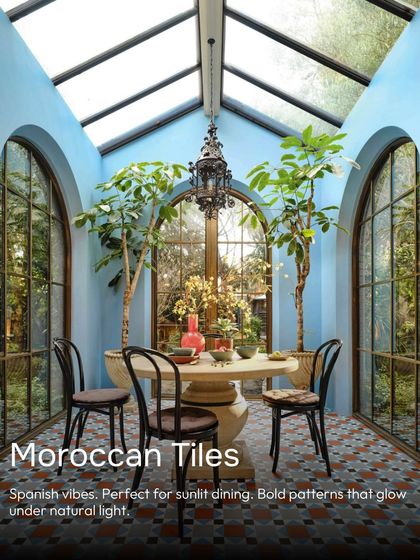 This sunroom has a Spanish vibe, with bold Moroccan tiles that glow under the natural light from the skylight. The arched windows and intricate patterns create a perfect spot for sunlit dining.