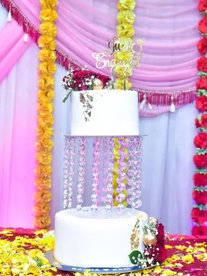 Another view of our chandelier cake, this time set up for an engagement party with a "Just Engaged" topper. The crystal details sparkle beautifully under the lights.