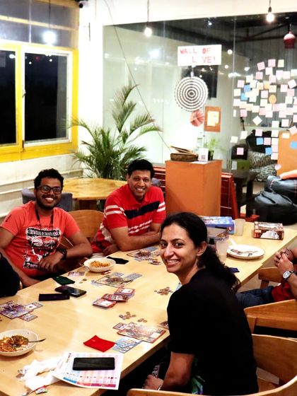 This group is having a great time playing 'Sheriff of Nottingham'. The 'Wall of Love' in the background is a testament to the community we've built.