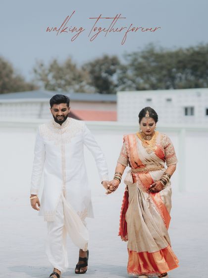 "Walking together forever." A classic shot of the couple walking hand-in-hand, capturing their journey forward in elegant South Indian wedding attire.